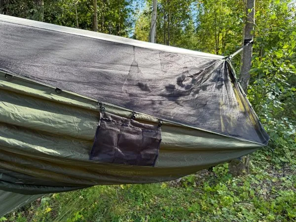 Mesh pocket hung under the edge of the hammock
