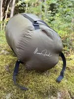 Olive 36 litre compression sack with the Momo Jord logo