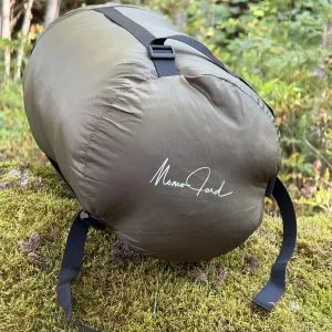 Olive 36 litre compression sack with the Momo Jord logo