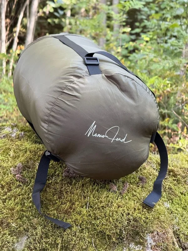 Olive 36 litre compression sack with the Momo Jord logo