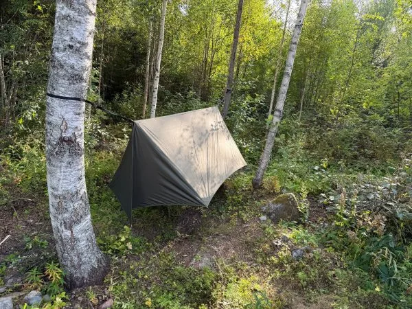 Winter tarp pitched low to the ground in storm mode