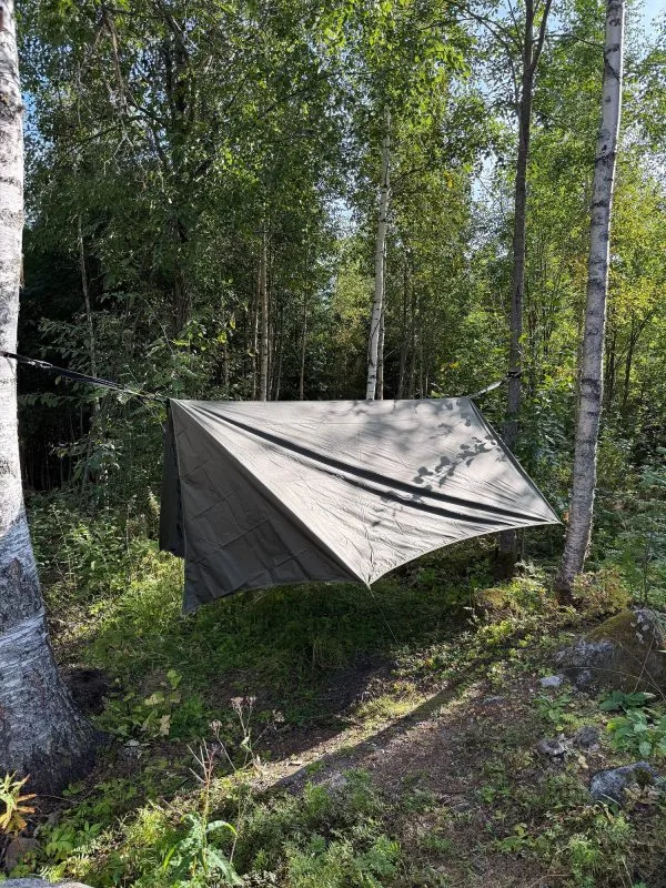 Winter tarp pitched with open ends and a clear view