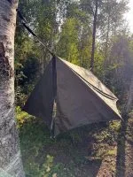 The winter tarp end flaps closed into a sheltered space